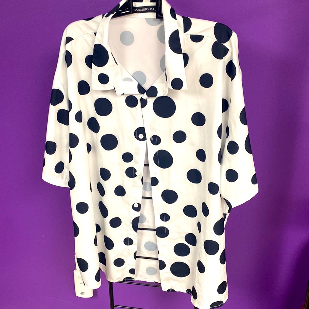 Casual white button-down shirt with various sized black polkadots